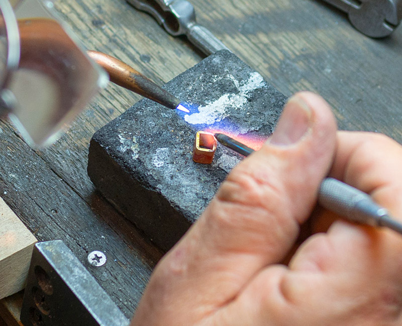 Close-up of Marc Howard working on a piece of custom jewelry in Santa Fe, NM