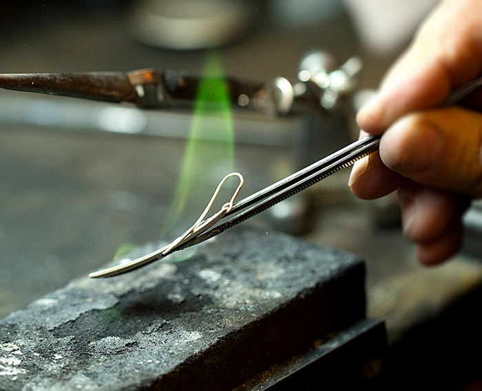 Close-up of Mark Howard working on an earring in his design studio in Santa Fe